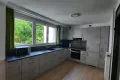 grey kitchen equipped with plenty of kitchen appliances and storing room