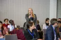 A Woman from the audience speaks into a microphone at the Academic Freedom Forum