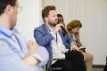 A Man from the audience speaks into a microphone at the Academic Freedom Forum