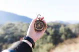 Person Holding Compass