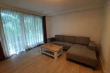 living room with floor-to ceiling-windows and spacious sofa in L-form