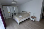 bedroom with double bed, spacious wardrobe, bedside table