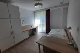 bedroom with bed, two desks, spacious wardrobe