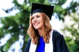 Smiling Girl with Red Hair Wearing Graduation Hat