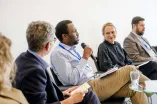 Panelist speaking into a Microphone at the Academic Freedom Forum
