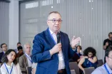 A Man from the audience speaks into a microphone at the Academic Freedom Forum