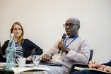 Panelist speaking into a Microphone at the Academic Freedom Forum