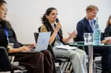 Panelist speaking into a Microphone at the Academic Freedom Forum
