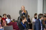 A Woman from the audience speaks into a microphone at the Academic Freedom Forum