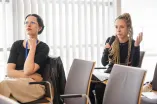A Woman from the audience speaks into a microphone at the Academic Freedom Forum