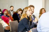 A Woman from the audience speaks into a microphone at the Academic Freedom Forum