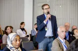 A man from the audience at Academic Freedom Forum speaks into a microphone standing up
