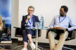 Isolde Karle speaking into a microphone at a panel of the Academic Freedom Forum