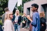 Participants of the Academic Freedom Forum speaking to each other during a coffee break, coffee mugs in hand