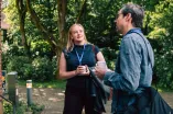 Participants of the Academic Freedom Forum speaking to each other during a coffee break in the Botanical Garden, coffee mugs in hand
