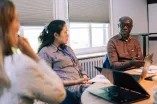 Three people discussing at one of the Working Group Sessions
