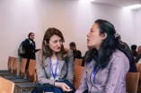 Two women from the audience speak to each other at the Academic Freedom Forum