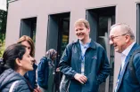 Participants talking th each other in front of a building