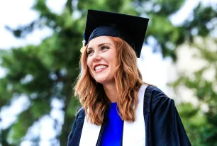 Smiling Girl with Red Hair Wearing Graduation Hat