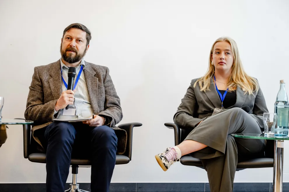 Panelist speaking into a Microphone at the Academic Freedom Forum