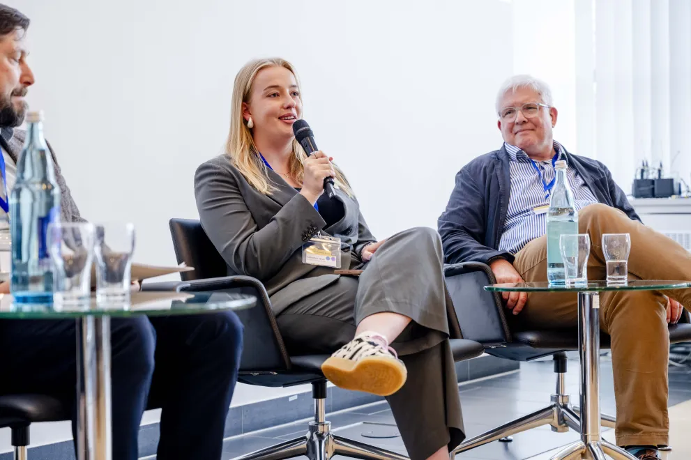 Panelist speaking into a Microphone at the Academic Freedom Forum