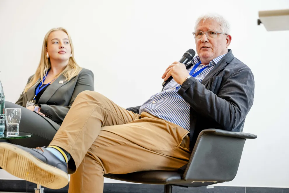 Panelist speaking into a Microphone at the Academic Freedom Forum