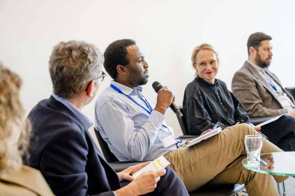 Panelist speaking into a Microphone at the Academic Freedom Forum
