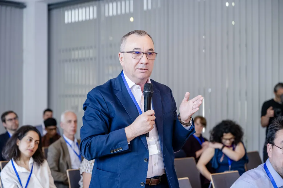 A Man from the audience speaks into a microphone at the Academic Freedom Forum
