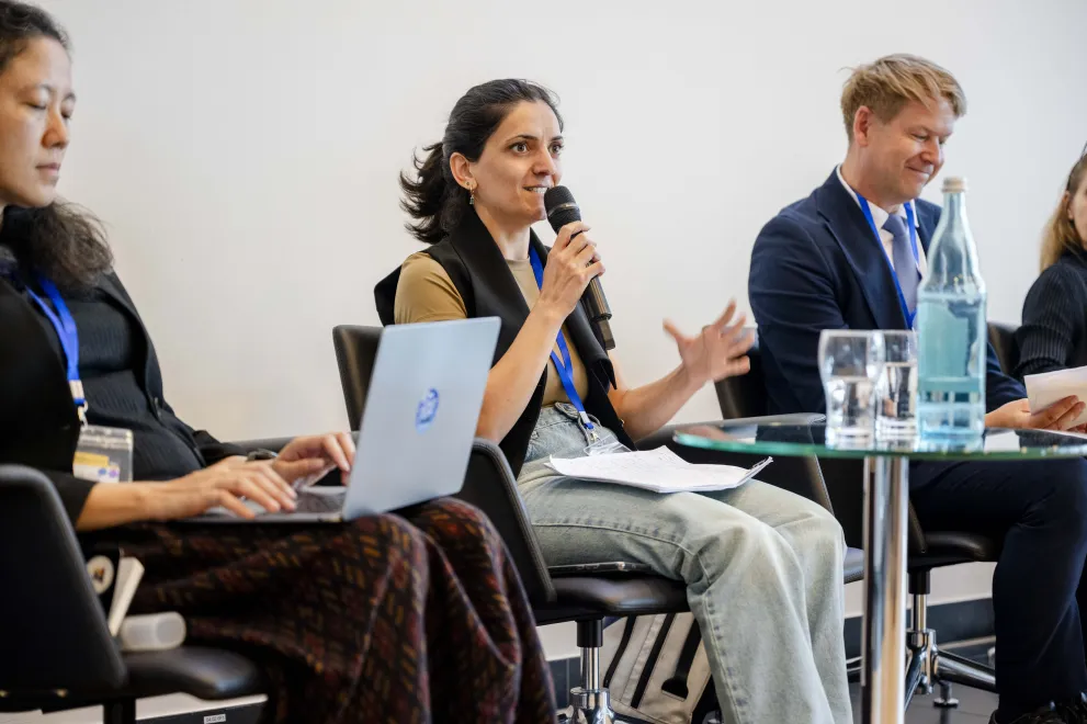 Panelist speaking into a Microphone at the Academic Freedom Forum
