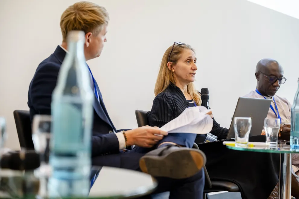 Panelist speaking into a Microphone at the Academic Freedom Forum