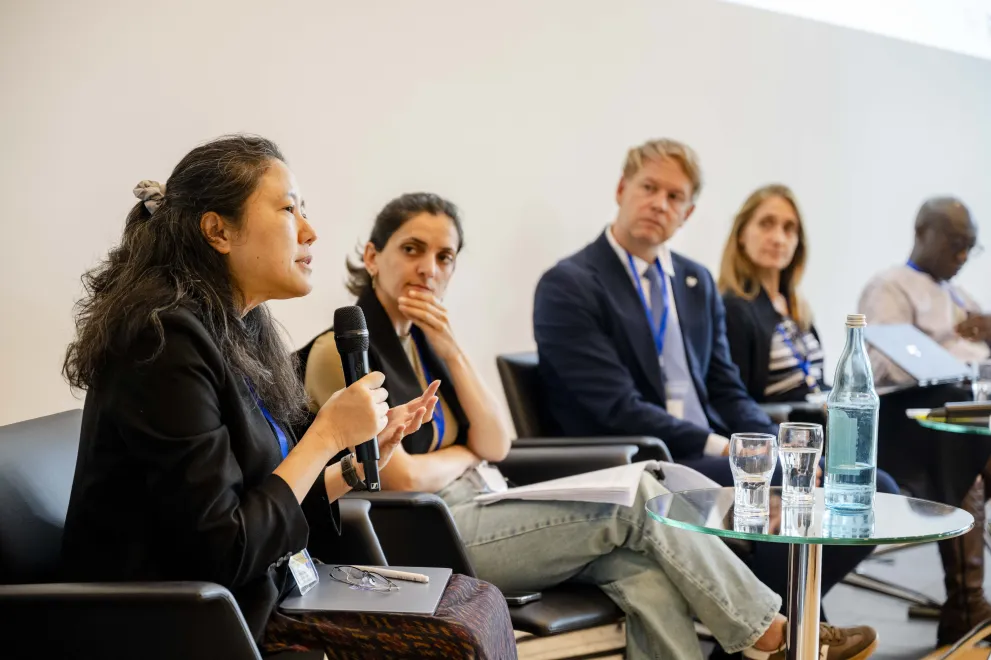 Panelist speaking into a Microphone at the Academic Freedom Forum