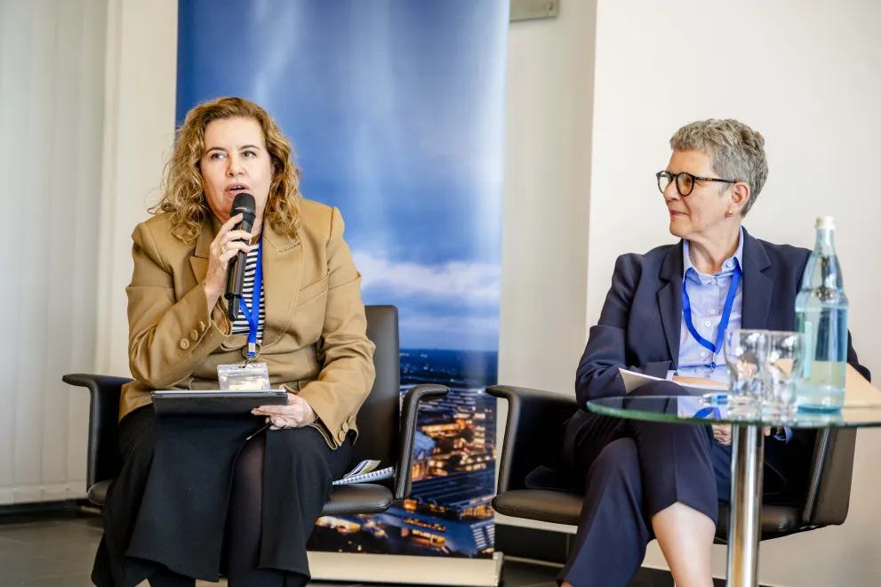 Panelist speaking into a Microphone at the Academic Freedom Forum