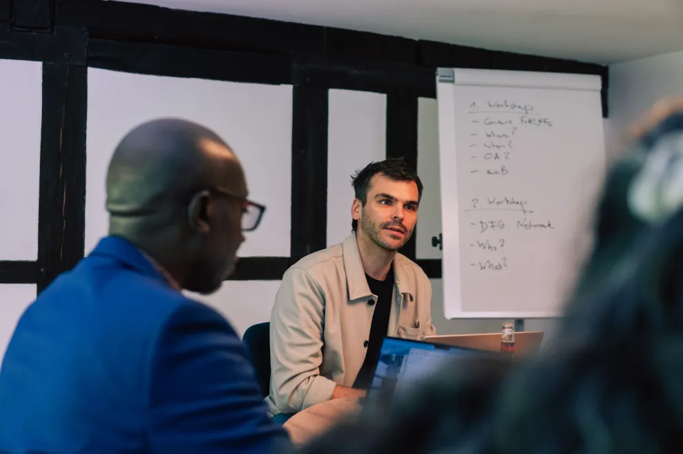 Two Workshop participants at the Academic Freedom Forum, Whiteboard in the Background.