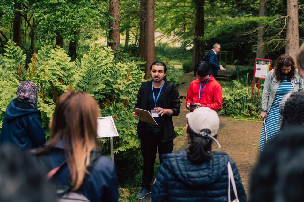  A man at the RUB Botanical Gardens speaks to the other Paticipants of the Garden of Sanctuary Walk.